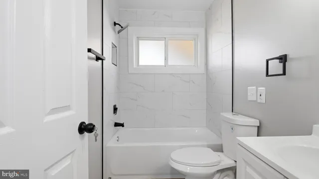 a bathroom with a toilet a sink and bathtub