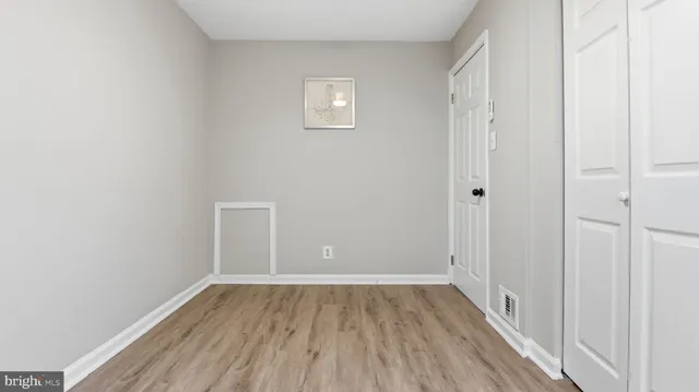 a view of a room with wooden floor