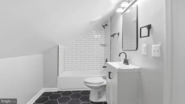 a bathroom with a toilet a sink and shower