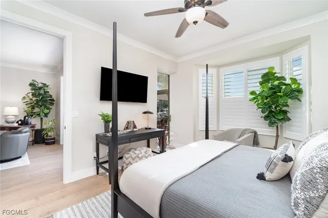 a bedroom with a bed and a potted plant