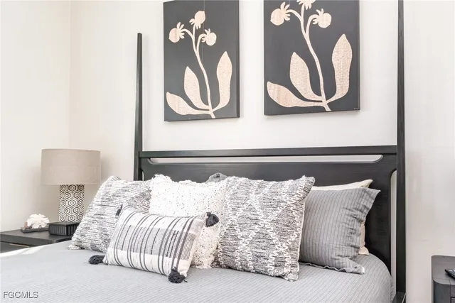 a bedroom with a bed and flowerpot