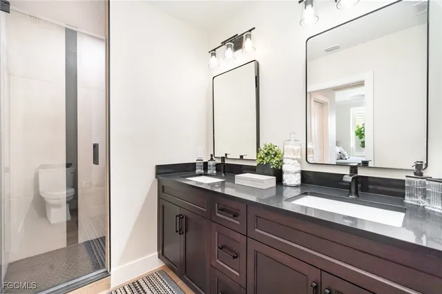 a bathroom with a double vanity sink and mirror