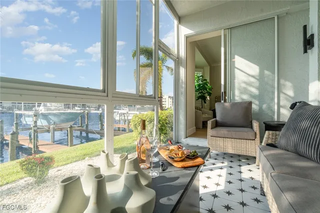 a living room with furniture and a floor to ceiling window