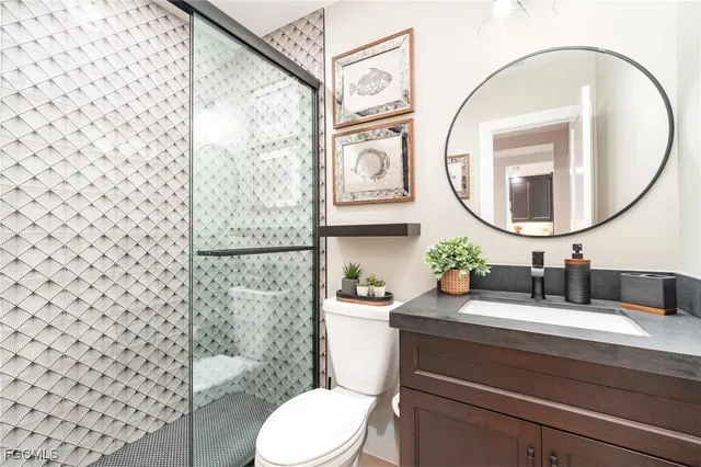 a bathroom with a sink a toilet and a mirror