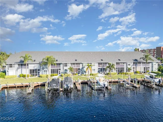a living room with furniture and kitchen