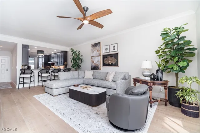 a living room with furniture potted plant and a window