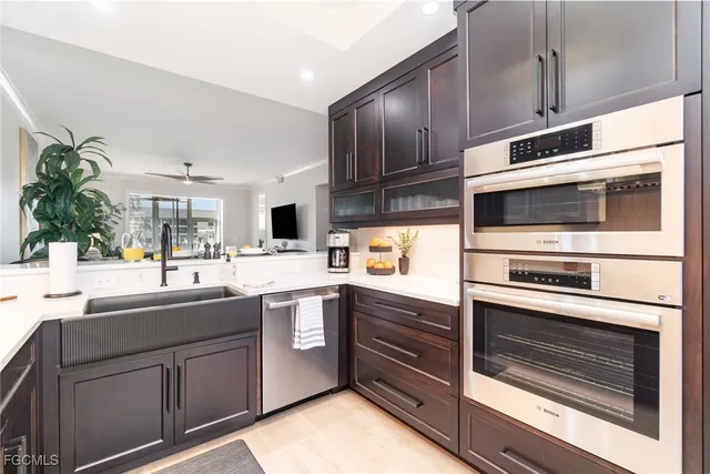 a kitchen with stainless steel appliances kitchen island granite countertop a sink and cabinets
