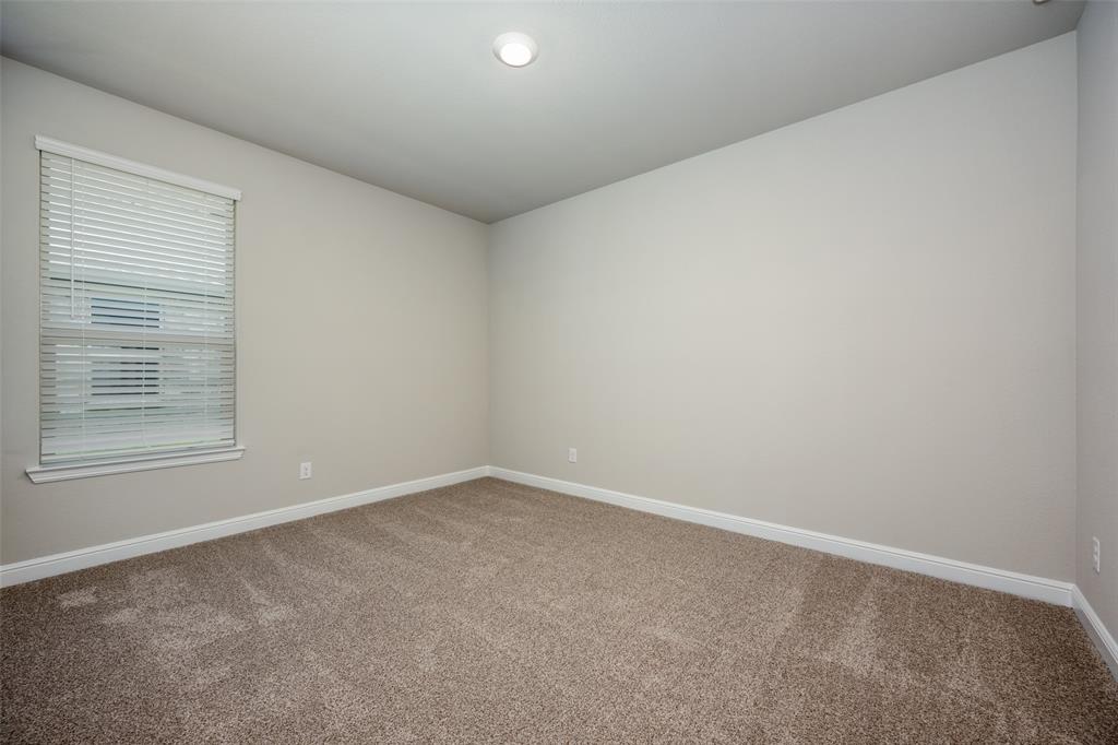 5231 Meadow Lane Krum, TX 76249 - Photo 7 of 17 Neutral-toned room featuring a single window with blinds, recessed ceiling lighting, light beige wall paint, white baseboards, and brown textured carpeting