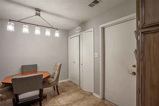 a view of a room with a table and chairs