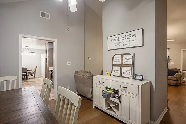 a view of a kitchen with fridge and wooden floor