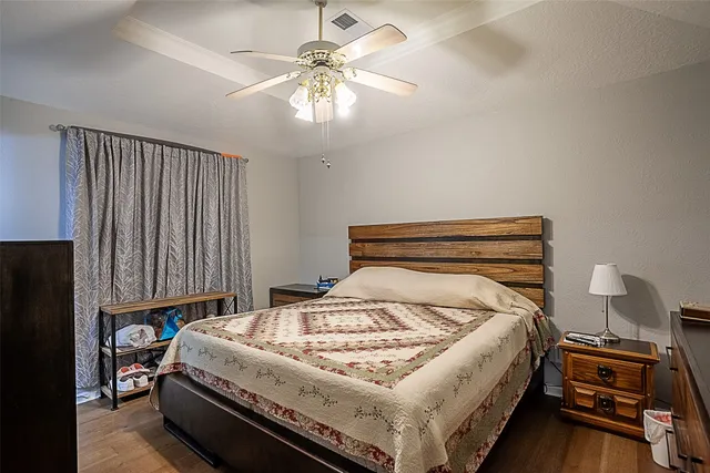 a bedroom with a bed and a chandelier