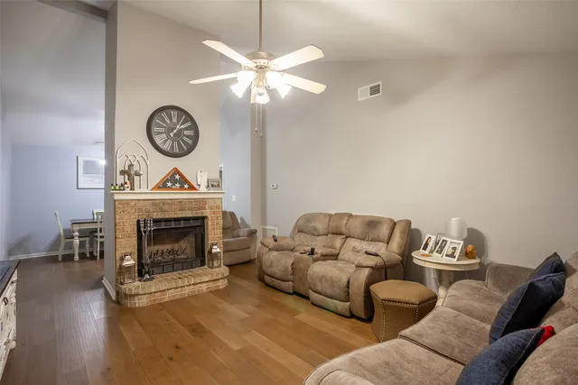 a living room with furniture a fireplace and a mirror