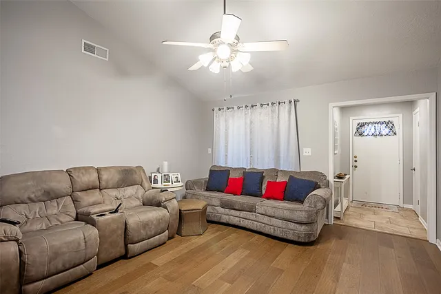 a living room with furniture and white walls