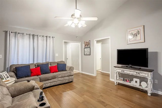 a living room with furniture and a flat screen tv