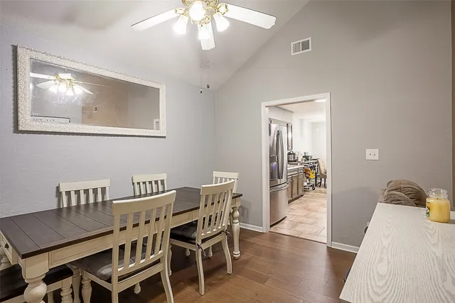 a view of a dining room with furniture and wooden floor