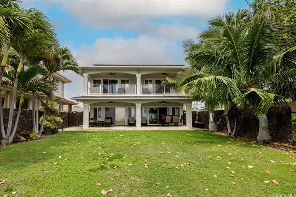 a front view of a house with a yard porch and sitting area