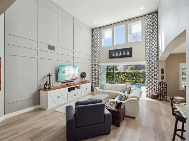 a kitchen with stainless steel appliances kitchen island granite countertop a table chairs sink and cabinets