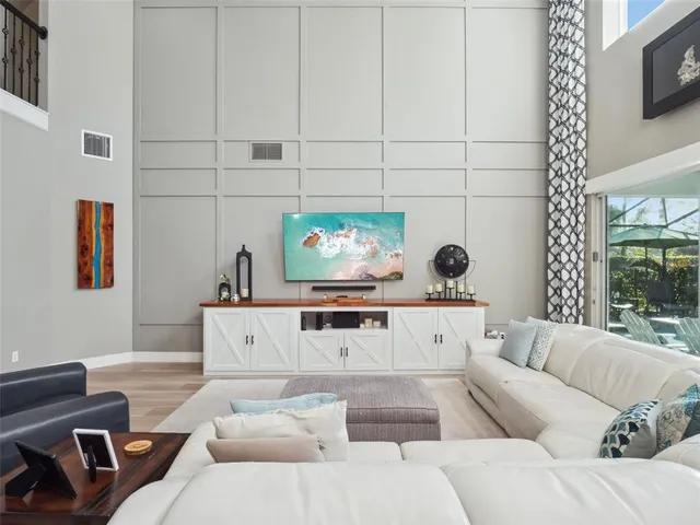 a kitchen with stainless steel appliances granite countertop a stove top oven a sink dishwasher a dining table and chairs with wooden floor