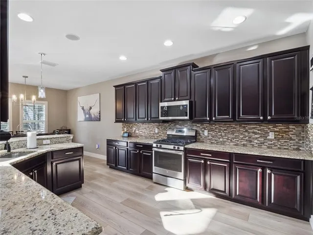 a bedroom with a large bed couch and a window
