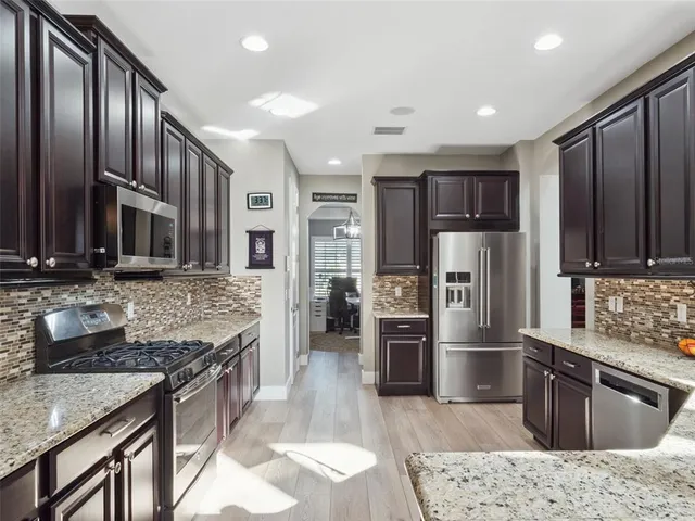 a spacious bathroom with a granite countertop double vanity sink and mirror