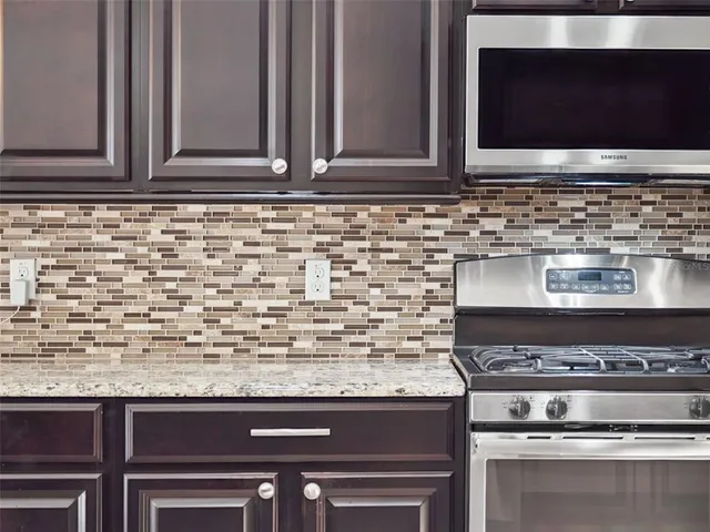 a spacious bathroom with a granite countertop tub sink and mirror