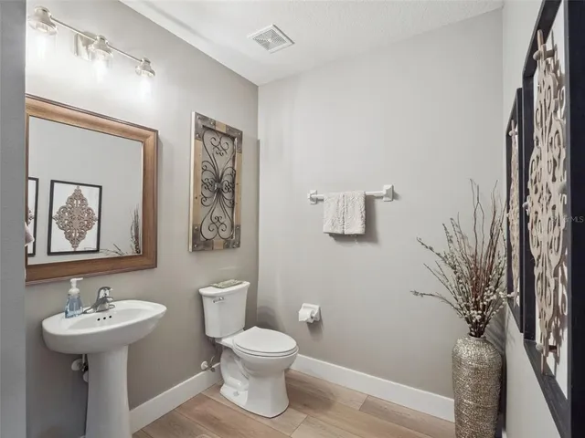 a bedroom with a bed and a potted plant