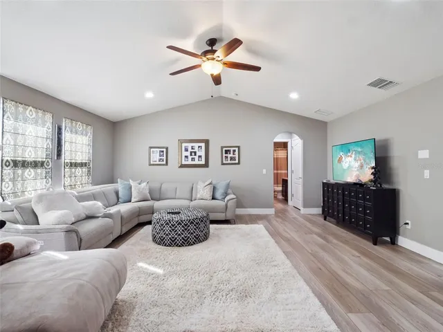 a bedroom with furniture and a ceiling fan