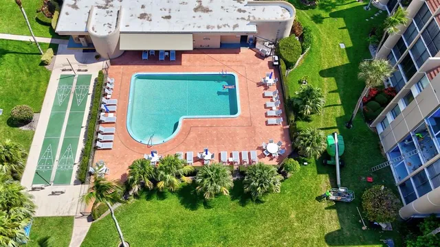 an aerial view of a house with a garden and trees