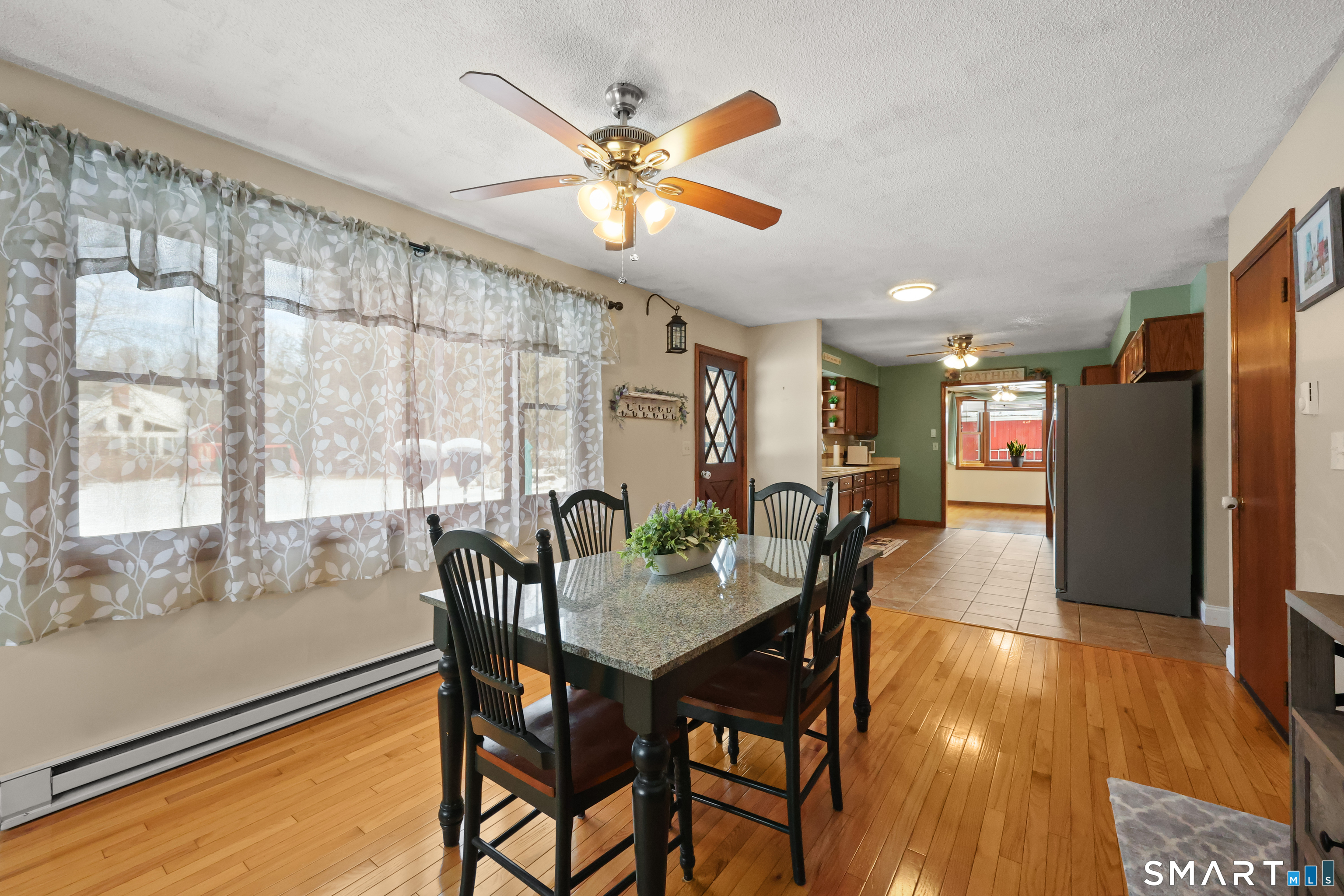 13 Basket Shop Road Hebron, CT 06248 - Photo 1 of 38 a view of a dining room with furniture window and wooden floor