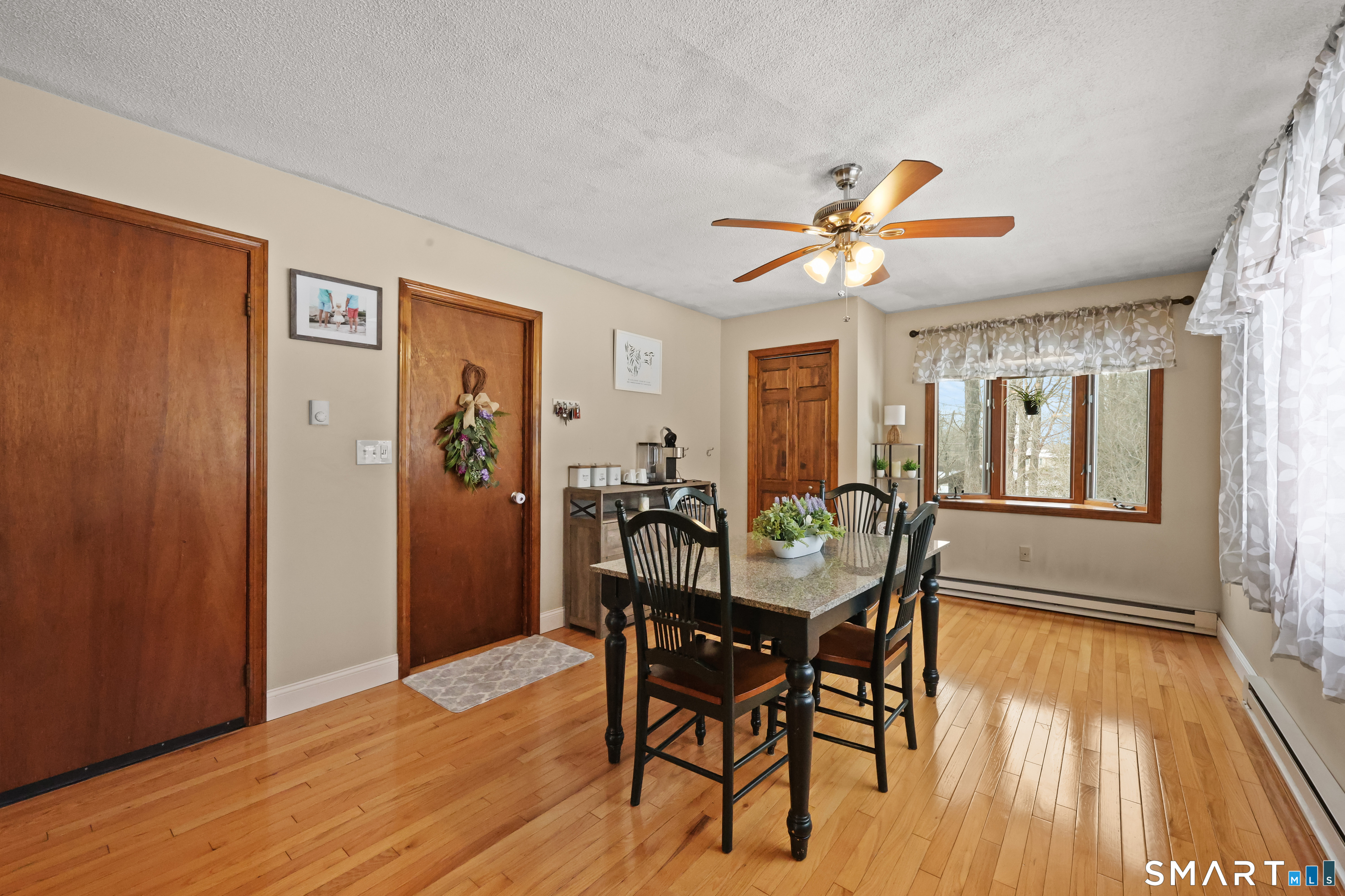 13 Basket Shop Road Hebron, CT 06248 - Photo 13 of 38 a view of a dining room with furniture window and wooden floor