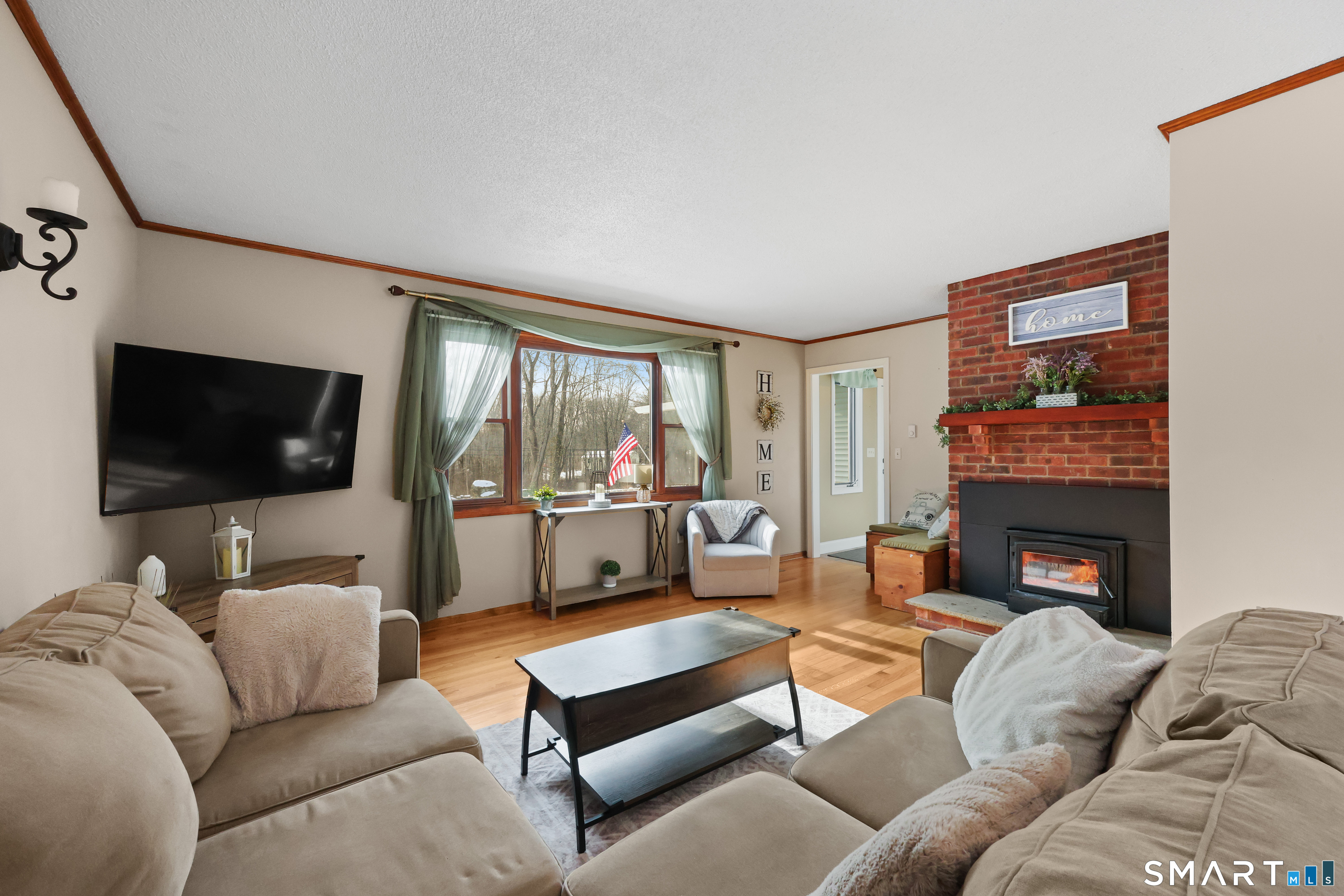 13 Basket Shop Road Hebron, CT 06248 - Photo 19 of 38 a living room with furniture a flat screen tv and a fireplace