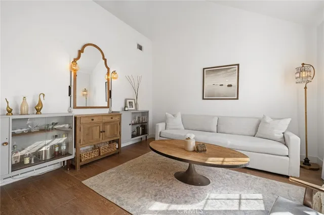 a living room with furniture a fireplace and a table