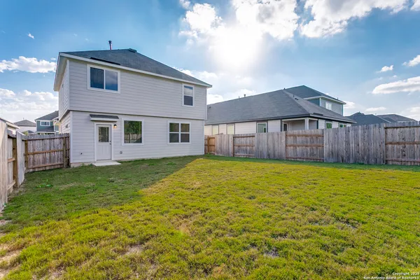 a view of a house with a backyard