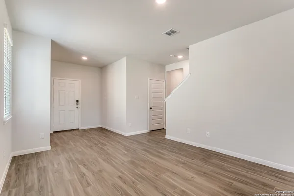 wooden floor in an empty room with a window