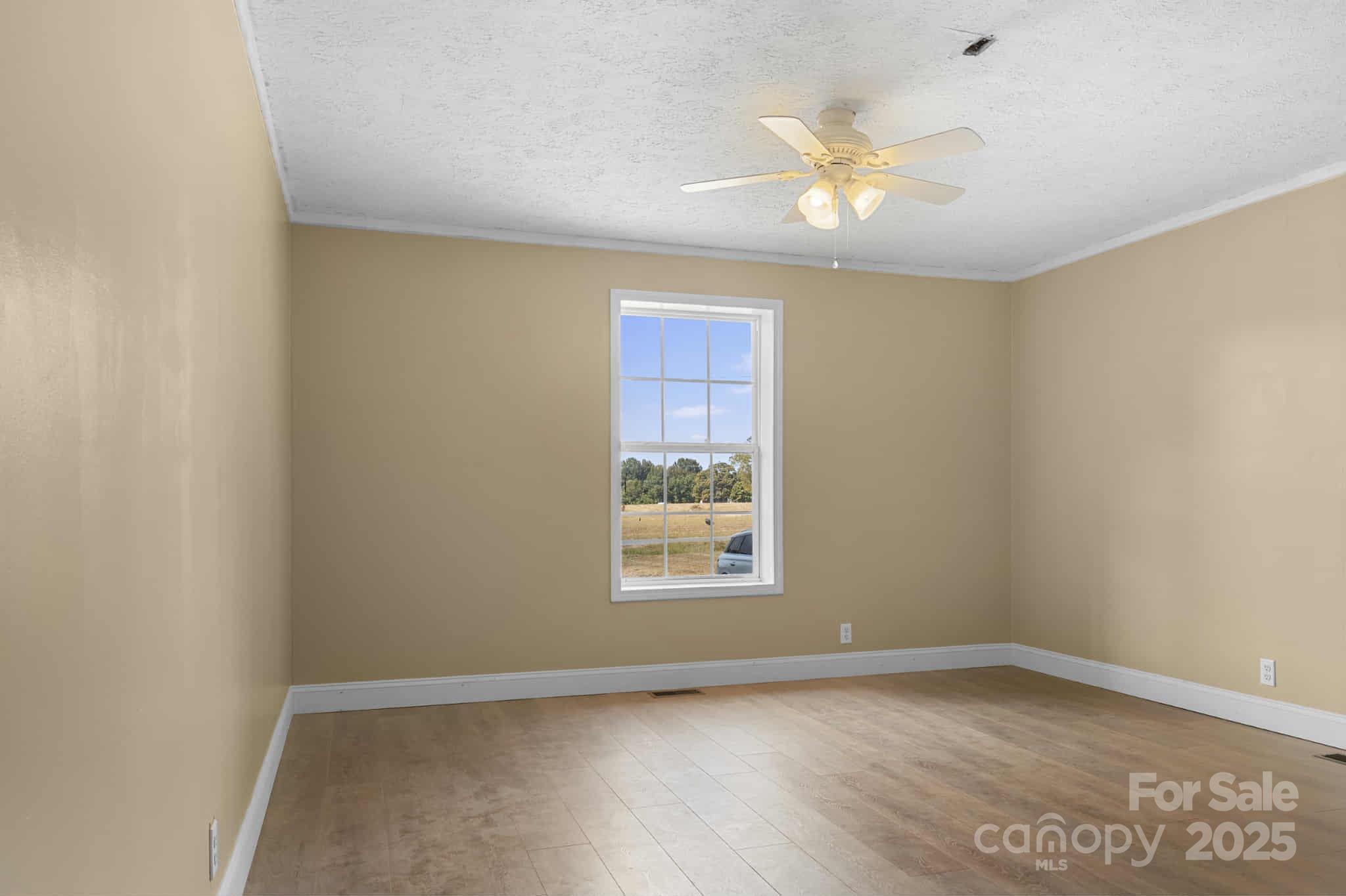 225 Lm Overcash Road Salisbury, NC 28146 - Photo 18 of 26 a view of an empty room with window and wooden floor