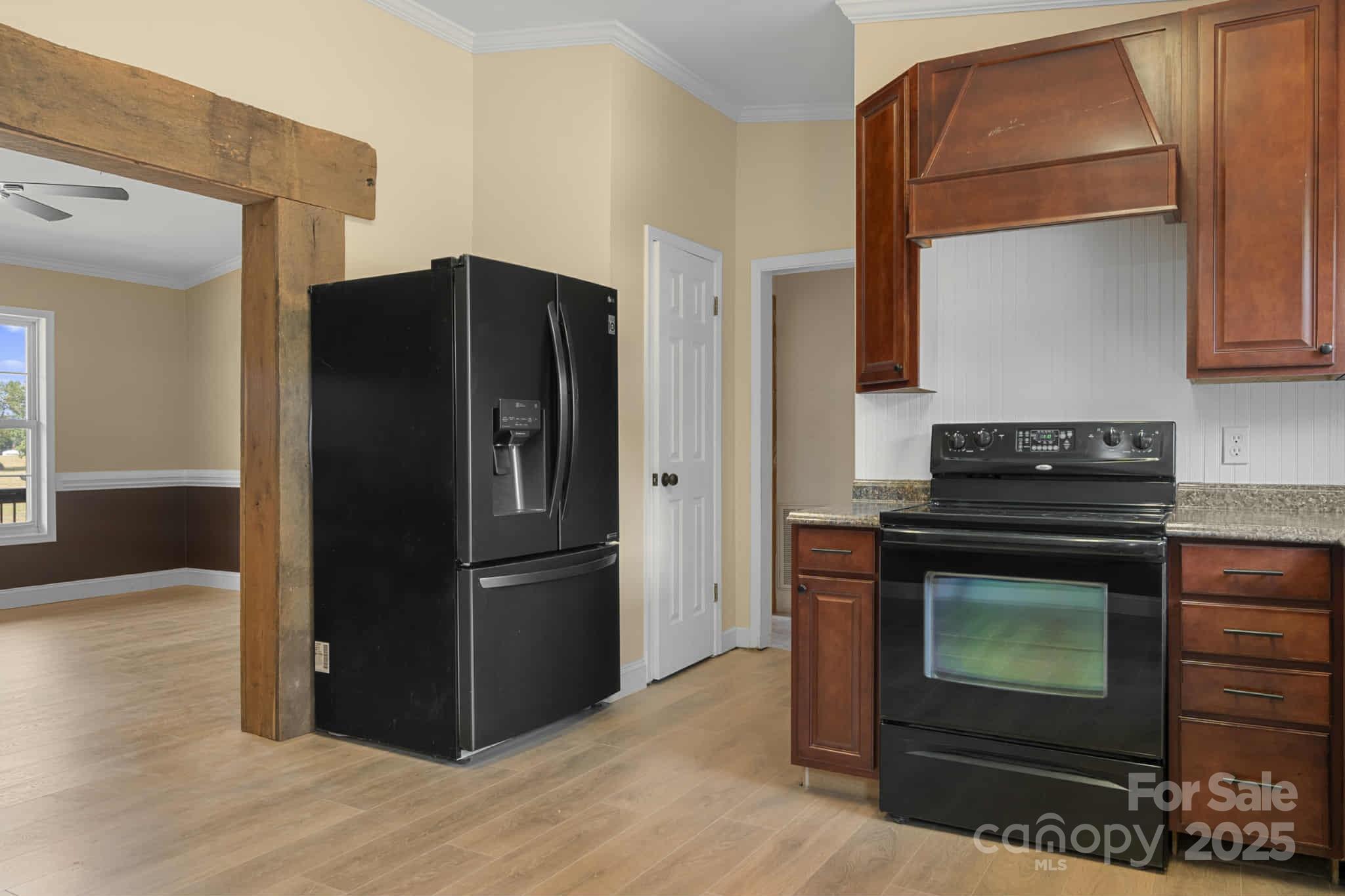 225 Lm Overcash Road Salisbury, NC 28146 - Photo 8 of 26 a kitchen with granite countertop a refrigerator and a stove top oven
