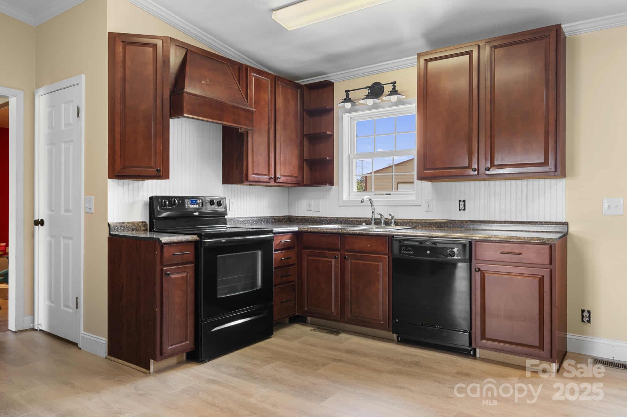 225 Lm Overcash Road Salisbury, NC 28146 - Photo 9 of 26 a kitchen with granite countertop wooden cabinets and a stove top oven