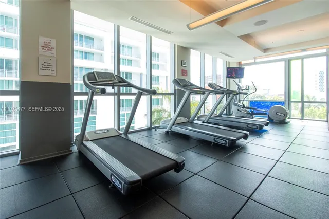 a living room with furniture and a floor to ceiling window