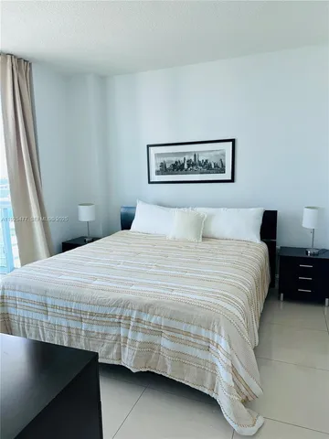 a bedroom with a bed and a night stand