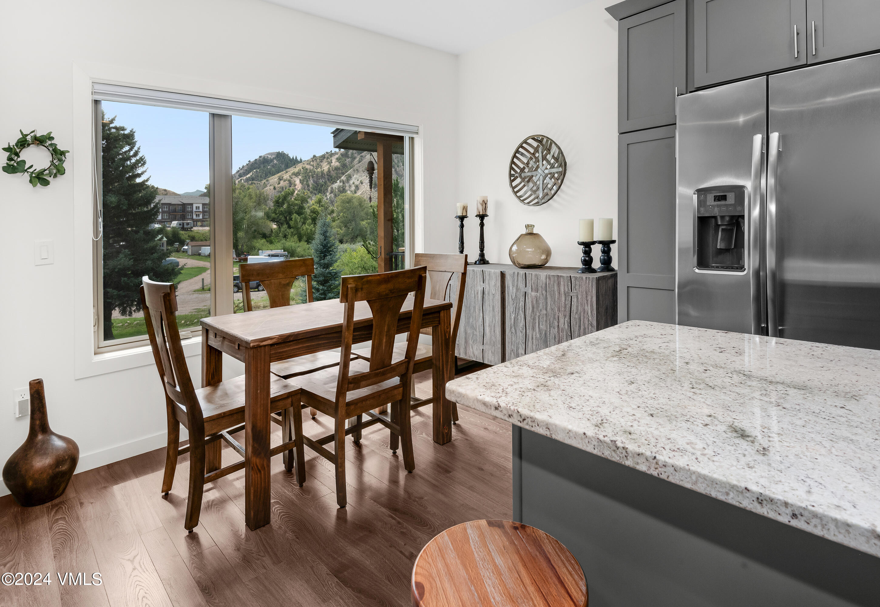36 Eagle Landing Way Eagle, CO 81631 - Photo 9 of 36 a kitchen with stainless steel appliances granite countertop a table chairs and wooden floor