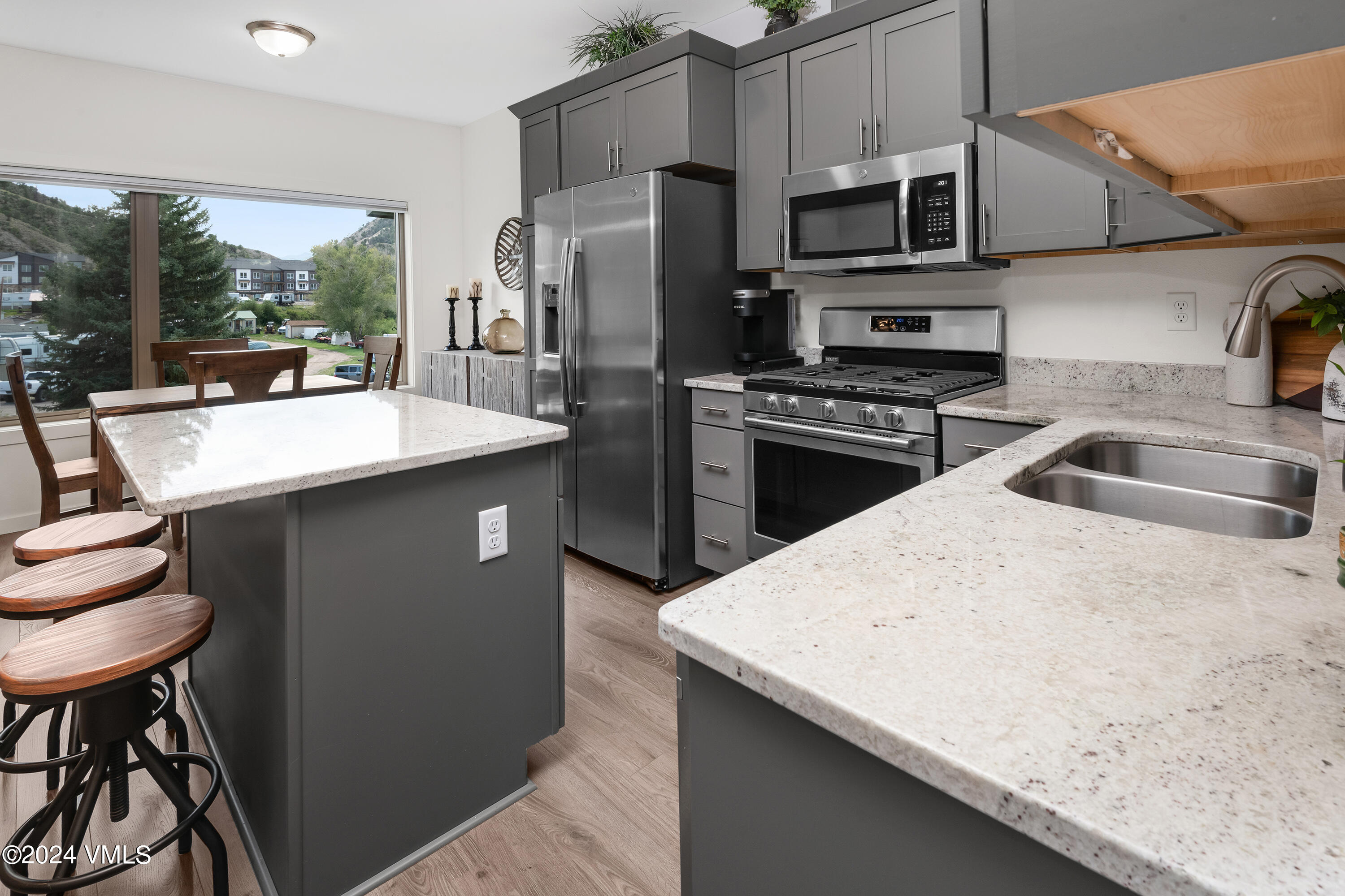 36 Eagle Landing Way Eagle, CO 81631 - Photo 10 of 36 a kitchen with stainless steel appliances a sink a stove a refrigerator a dining table and chairs