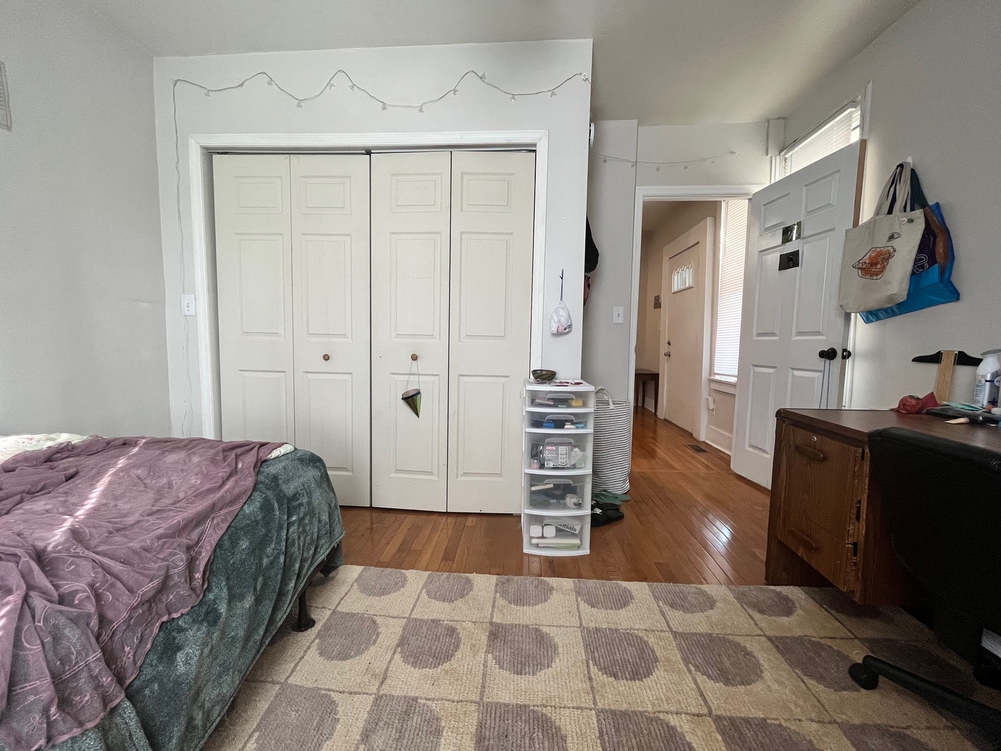 706 West High Street Urbana, IL 61801 - Photo 15 of 21 a bedroom with a bed and dresser with mirror