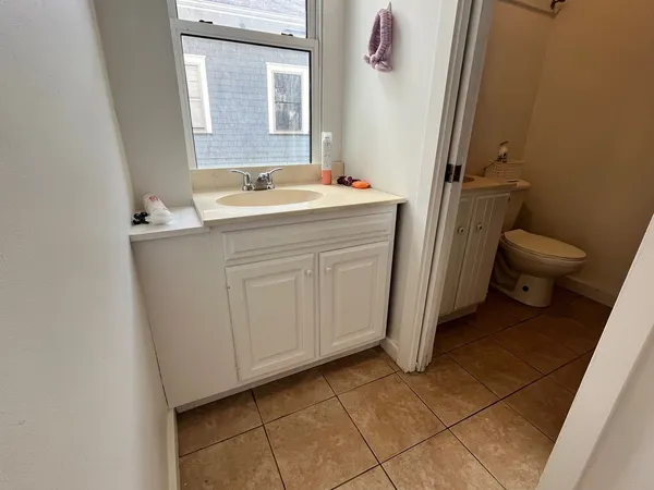 a bathroom with a sink toilet and mirror