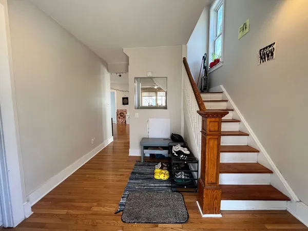 a room with wooden floor and stairs