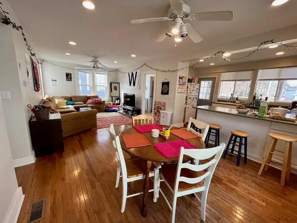 a view of a dining room with furniture and wooden floor