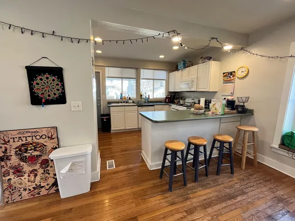 a large kitchen with a table and chairs