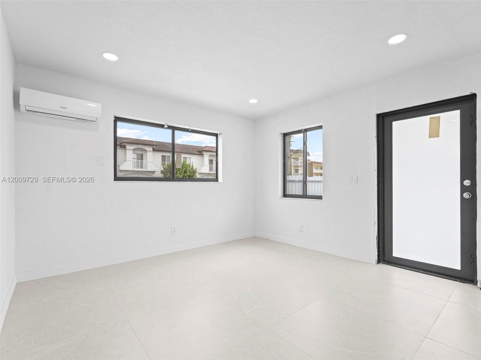 1370 West 29th Street, Unit B Hialeah, FL 33012 - Photo 11 of 15 an empty room with windows and closet