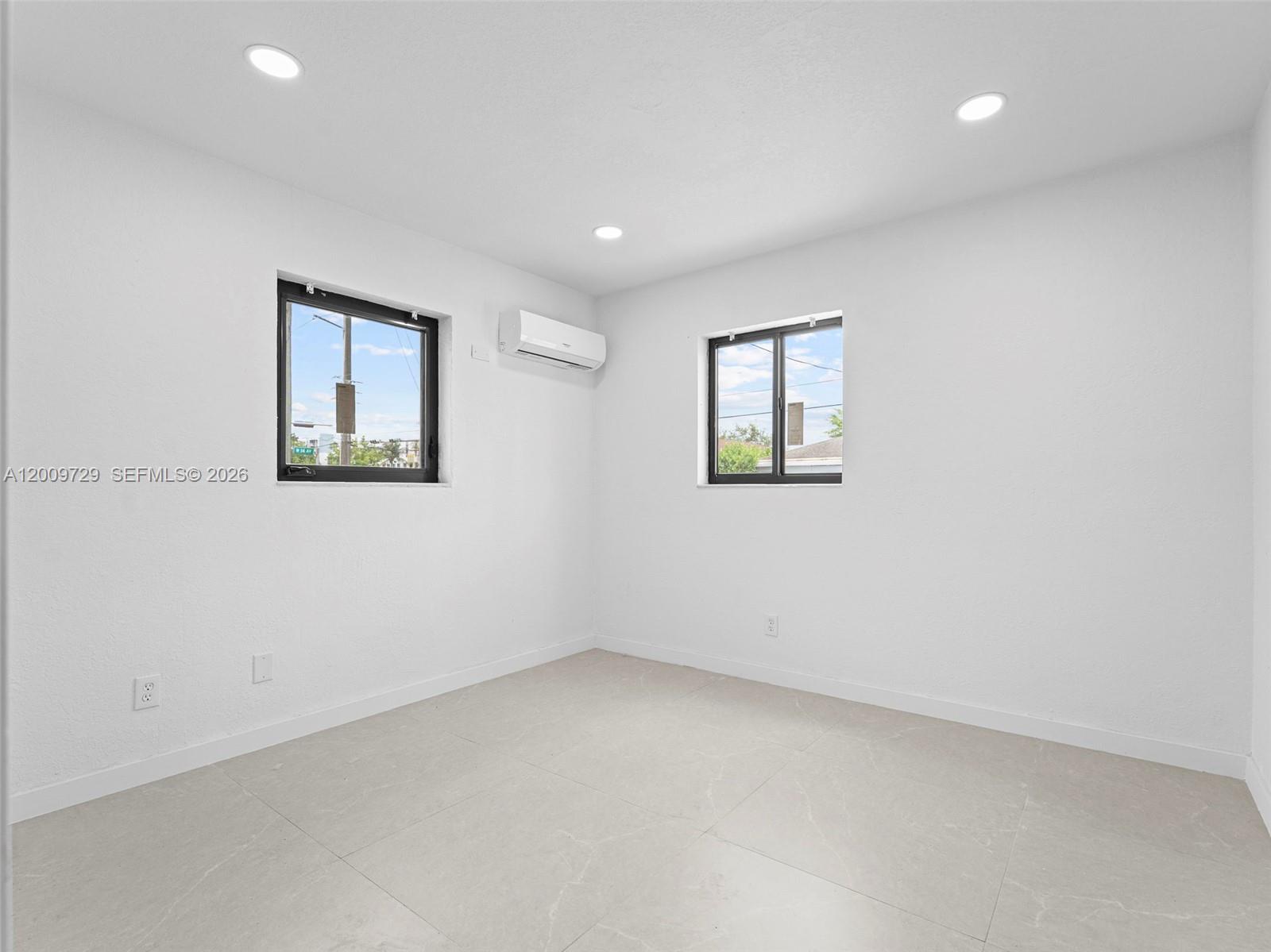 1370 West 29th Street, Unit B Hialeah, FL 33012 - Photo 12 of 15 an empty room with windows