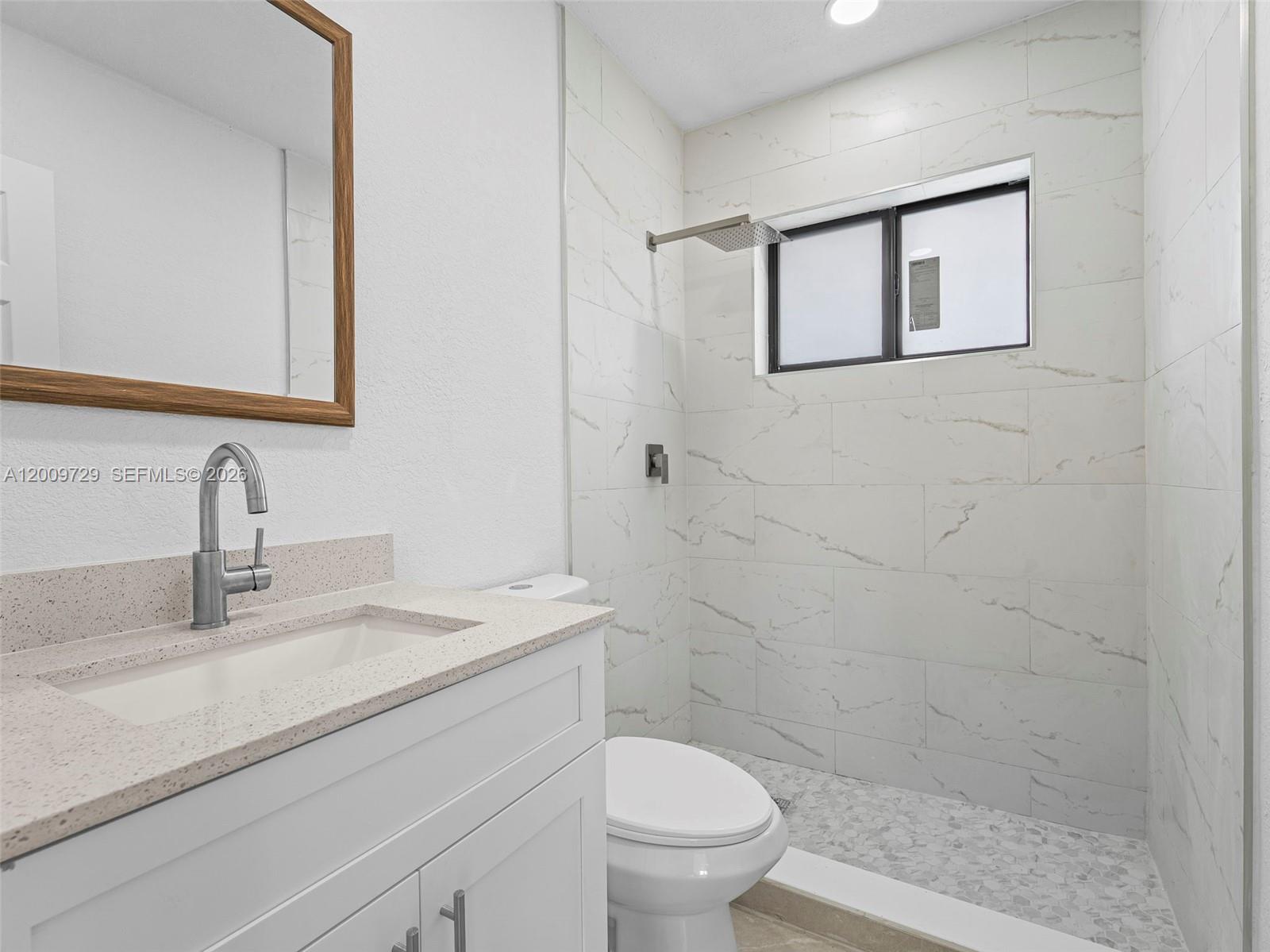 1370 West 29th Street, Unit B Hialeah, FL 33012 - Photo 13 of 15 a bathroom with a sink a toilet and shower