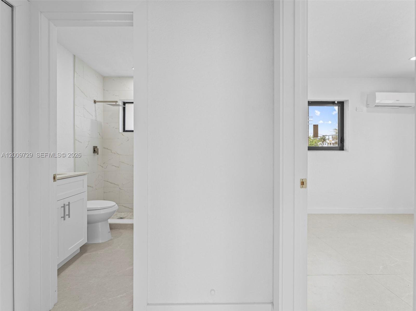1370 West 29th Street, Unit B Hialeah, FL 33012 - Photo 14 of 15 a bathroom with a granite countertop toilet and a shower